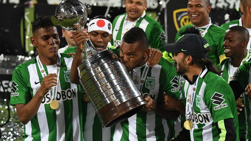 Fans of Atletico Nacional celebrate at the end of a second leg