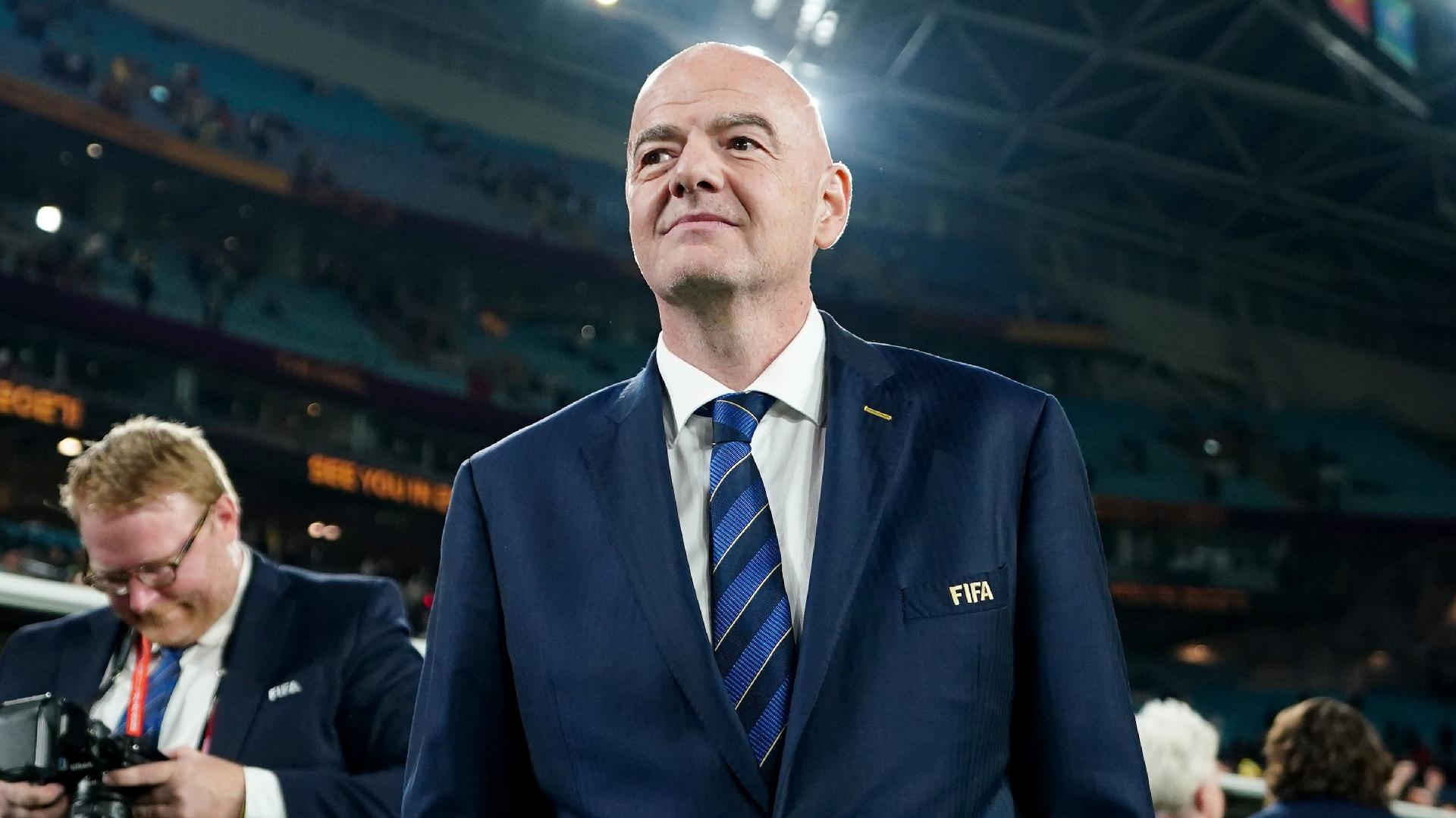 FIFA president Gianni Infantino shows the red card to blue cards