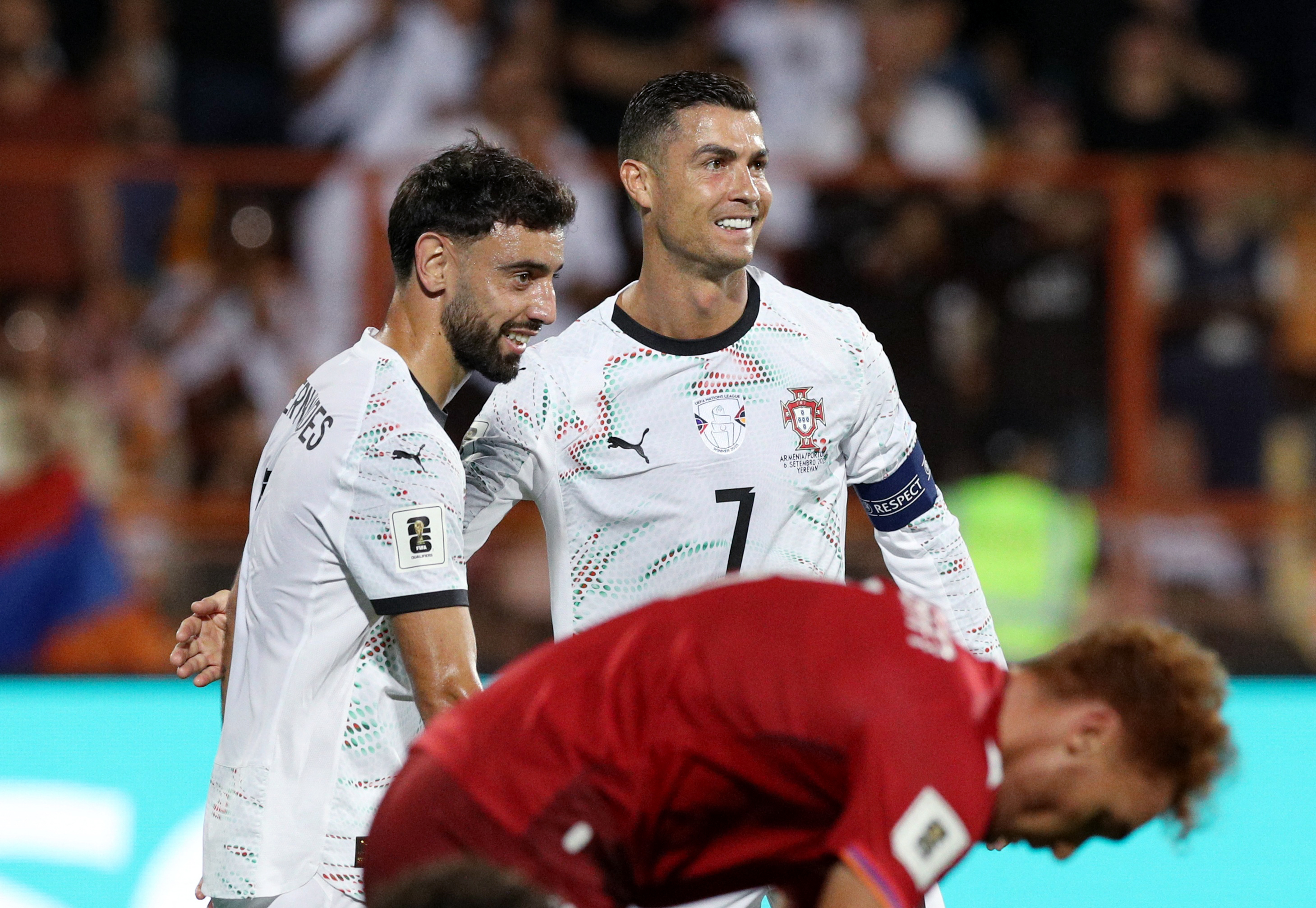 Portugal's influential midfielders, Bruno Fernandes and Cristiano Ronaldo, demonstrating unity and shared ambition for the upcoming FIFA World Cup.